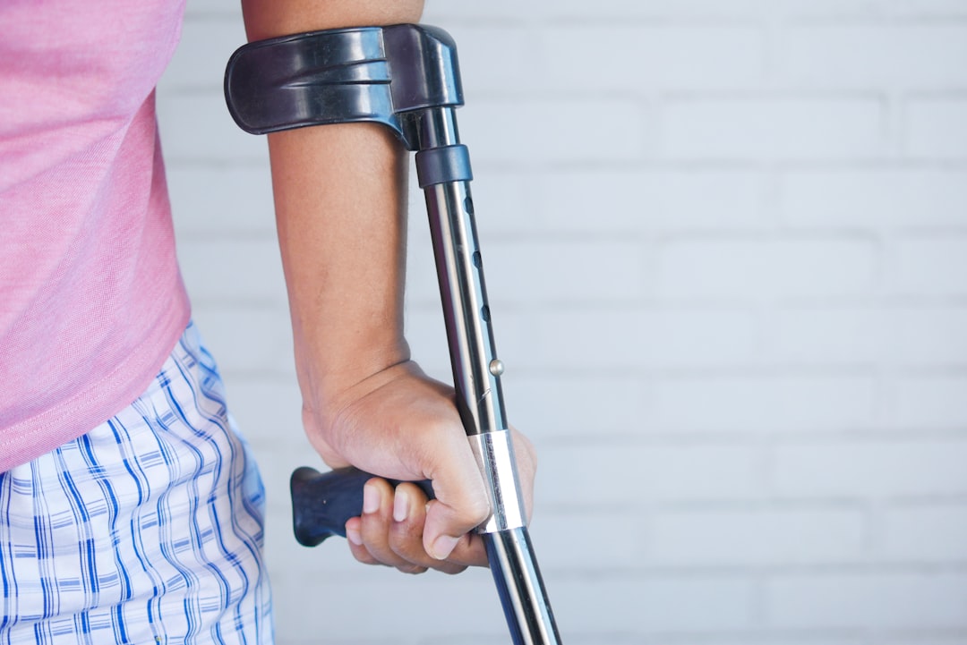 a-person-holding-a-crutch-and-walking-cane-b3pxvcnbssi